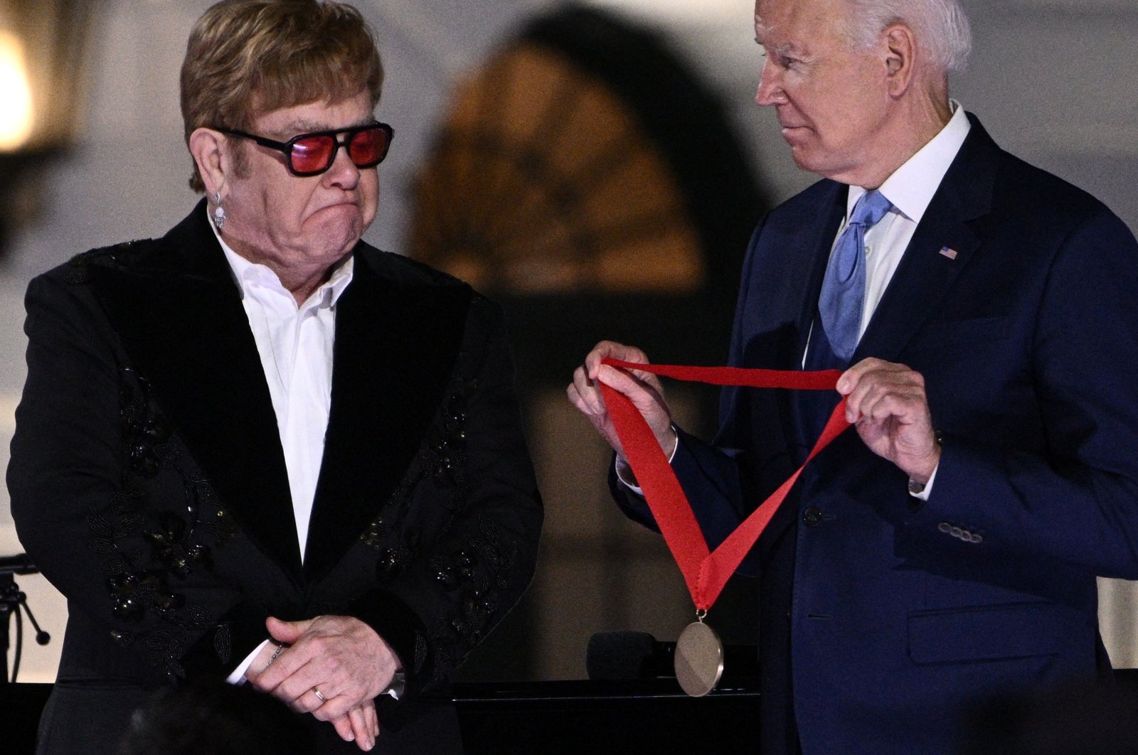 British singer Elton John gets emotional as U.S. President Joe Biden presents him with the National Humanities Medal at the end of &quot;A Night When Hope and History Rhyme&quot; at the White House in Washington, D.C., U.S., Sept. 23, 2022. (AFP Photo)