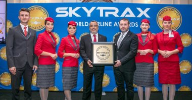 Turkish Airlines Chairperson of the Board and the Executive Committee Ahmet Bolat (C) receives an award during the Skytrax World Airline Awards 2022, London, U.K., Sept. 23, 2022. (DHA Photo)