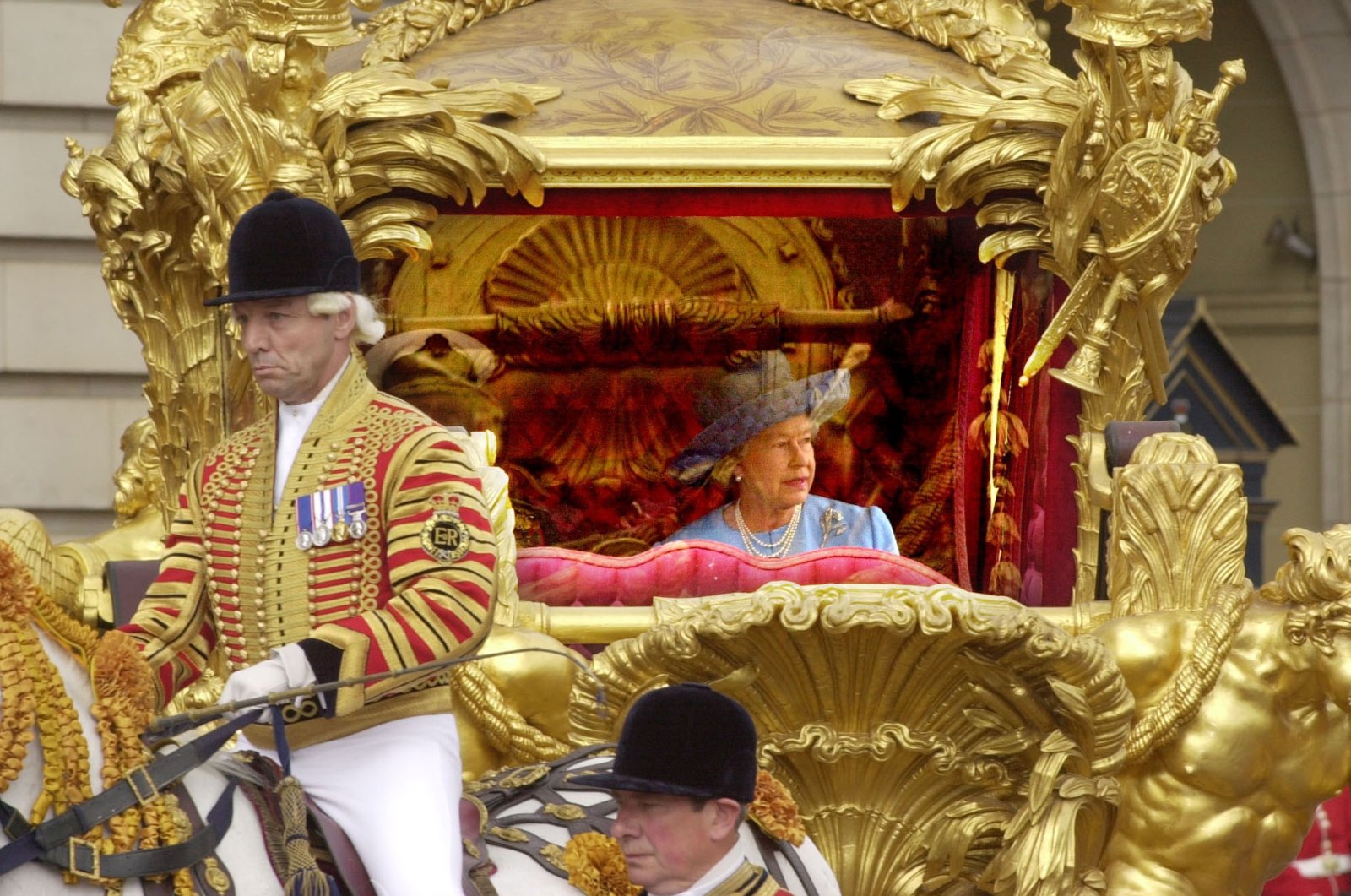Queen Elizabeth II with her husband Prince Philip, ride in the State Gold Coach en route to St. Paul&#039;s Cathedral in London, U.K., June 4, 2002. (AP Photo)