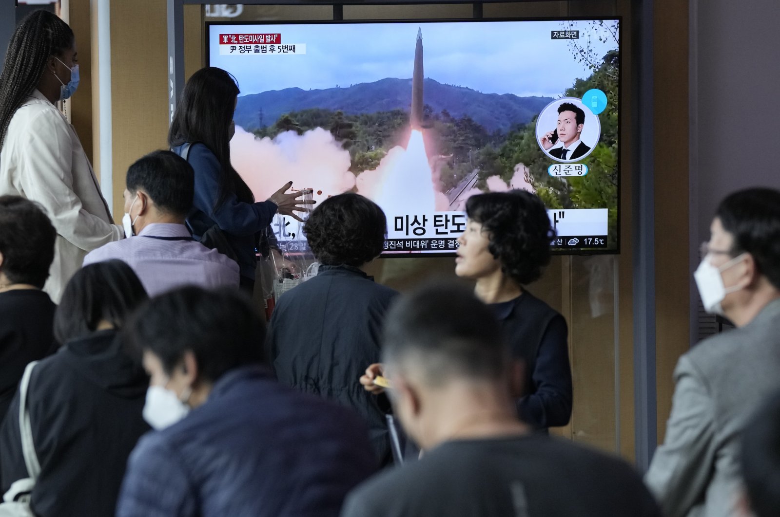 People watch a news program showing a file image of a missile launch by North Korea at the Seoul Railway Station in Seoul, South Korea, Sept. 25, 2022. (AP Photo)