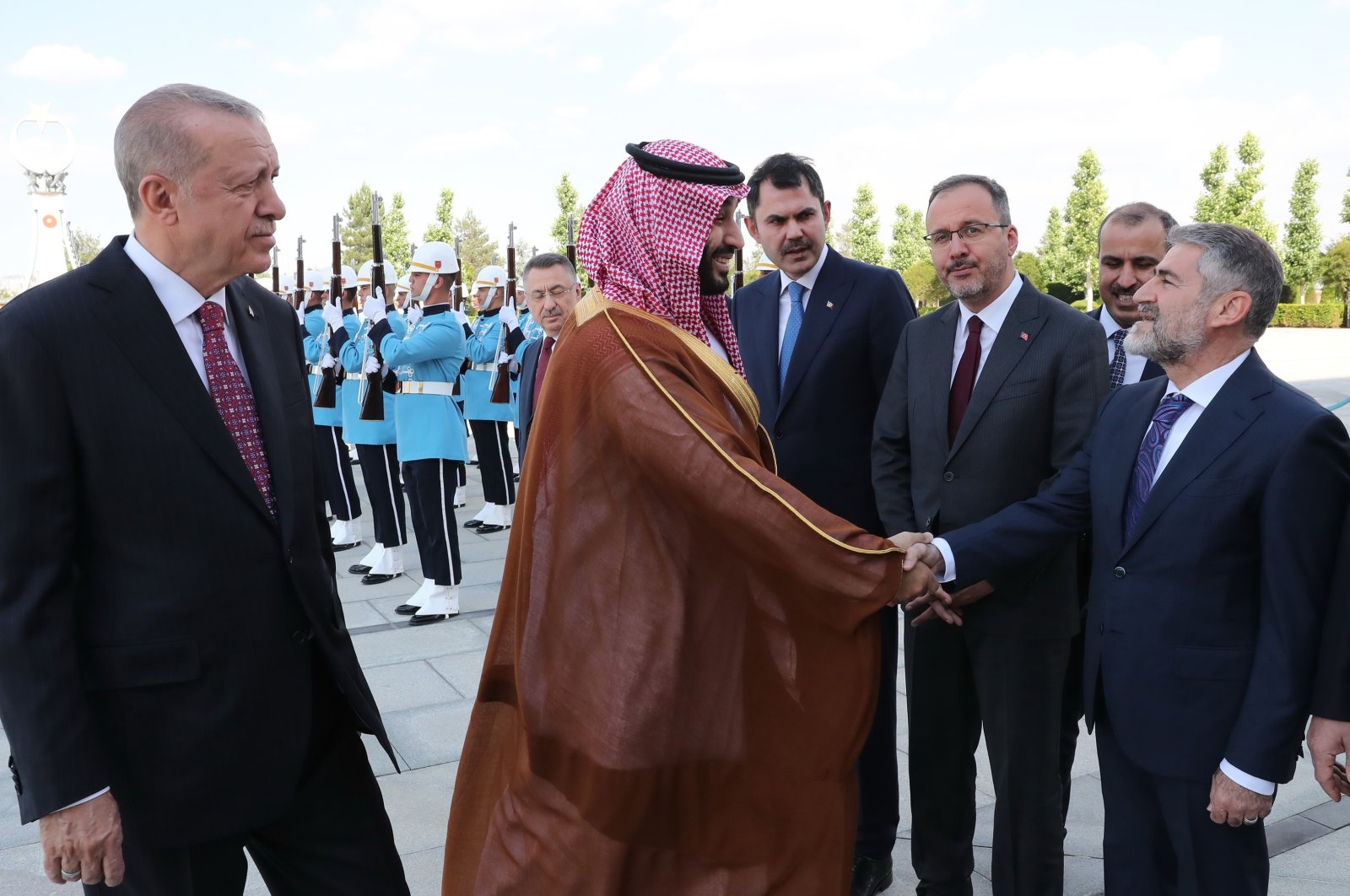 Saudi Arabia’s Crown Prince Mohammed bin Salman (2nd L) shakes hands with Türkiye’s Treasury and Finance Minister Nureddin Nebati (R) as he is welcomed by President Recep Tayyip Erdoğan (L) in Ankara, Türkiye, June 22, 2022. (AA Photo)