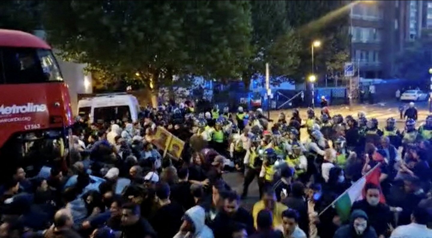 Police confront protesters during demonstrations following the death of Mahsa Amini in Iran, in London, Britain, Sept. 25, 2022 in this screen grab obtained from social media video.  (Photo via Reuters)