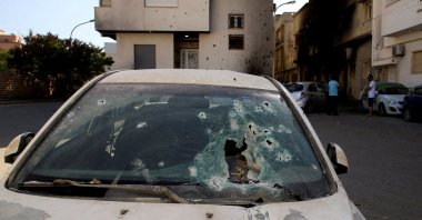 Holes are seen in the windshield of a destroyed car following clashes in Tripoli, Libya, Aug. 28, 2022. (Reuters Photo)