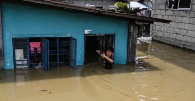 A resident enters his flooded home in the aftermath of Super Typhoon Noru, San Ildefonso, the Philippines, Sept. 26, 2022. (AFP Photo)