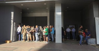 People queue as they wait to withdraw money from ATM cash machines in Sidon, Lebanon, Sept. 26, 2022. (Reuters Photo)