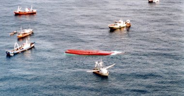 In this handout file photograph released by France's Marine Nationale on Sept. 27, 2002, fishing boats carrying rescuers search for those missing and feared drowned after the passenger ferry Le Joola (C), capsized in stormy seas off the coast of the west African nation of Senegal. (Marine Nationale via AFP)