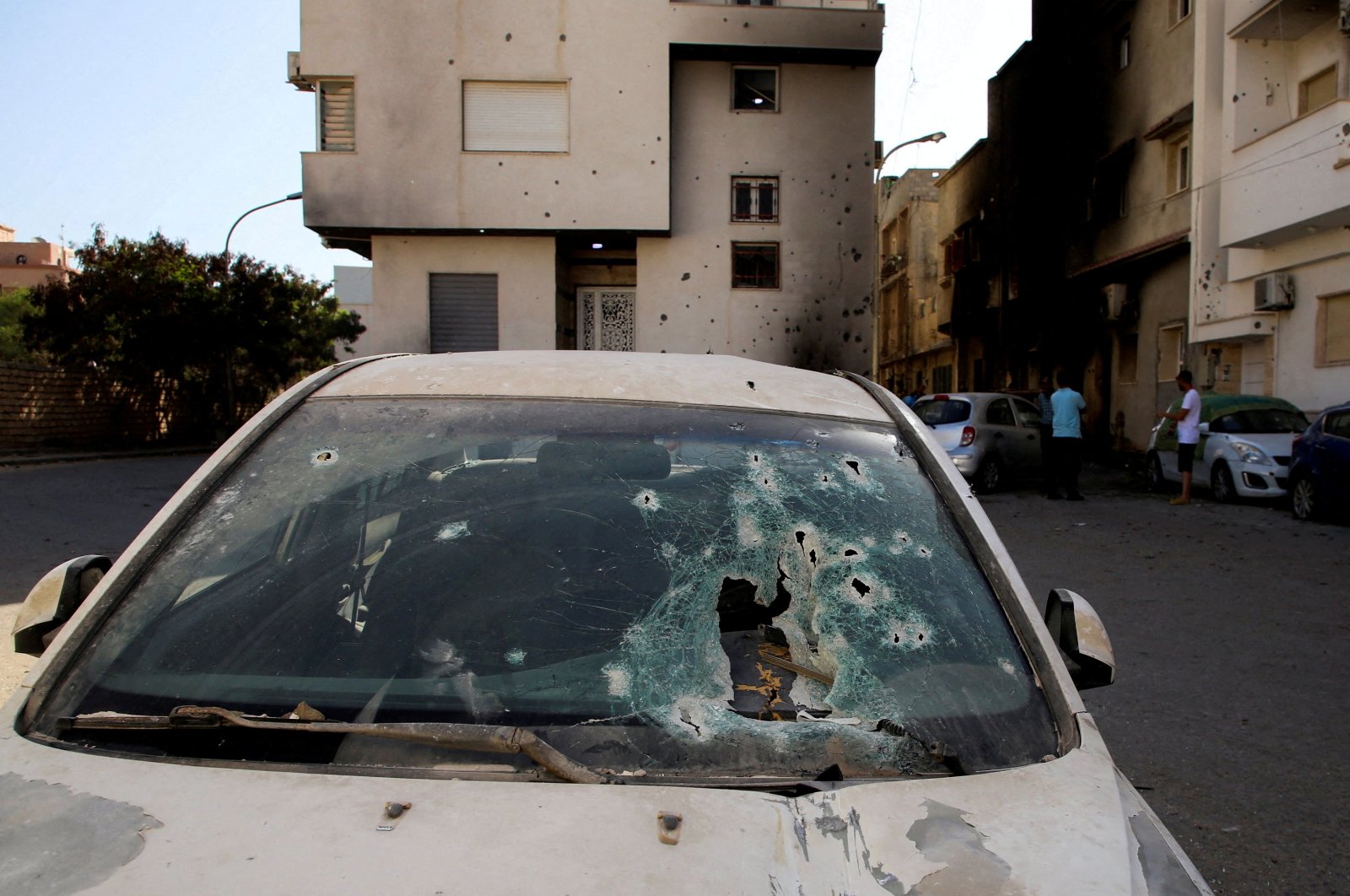 Holes are seen in the windshield of a destroyed car following clashes in Tripoli, Libya, Aug. 28, 2022. (Reuters Photo)