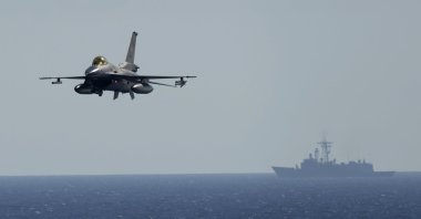 A Turkish F16 fighting jet flies over naval ships during an annual NATO naval exercise on Türkiye&#039;s western coast off the Mediterranean, Sept. 15, 2022. (AP Photo)