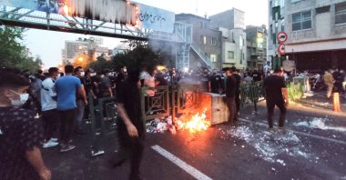 Iranian demonstrators burn a rubbish bin during a protest for Mahsa Amini, Tehran, Iran, Sept. 21, 2022. (AFP Photo)