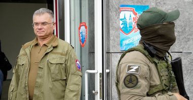 Konstantin Ivashchenko (L), former CEO of the Azovmash plant and appointed pro-Russian mayor of Mariupol, visits a polling station as people vote in a referendum in Mariupol, Ukraine, Sept. 27, 2022. (AFP Photo)