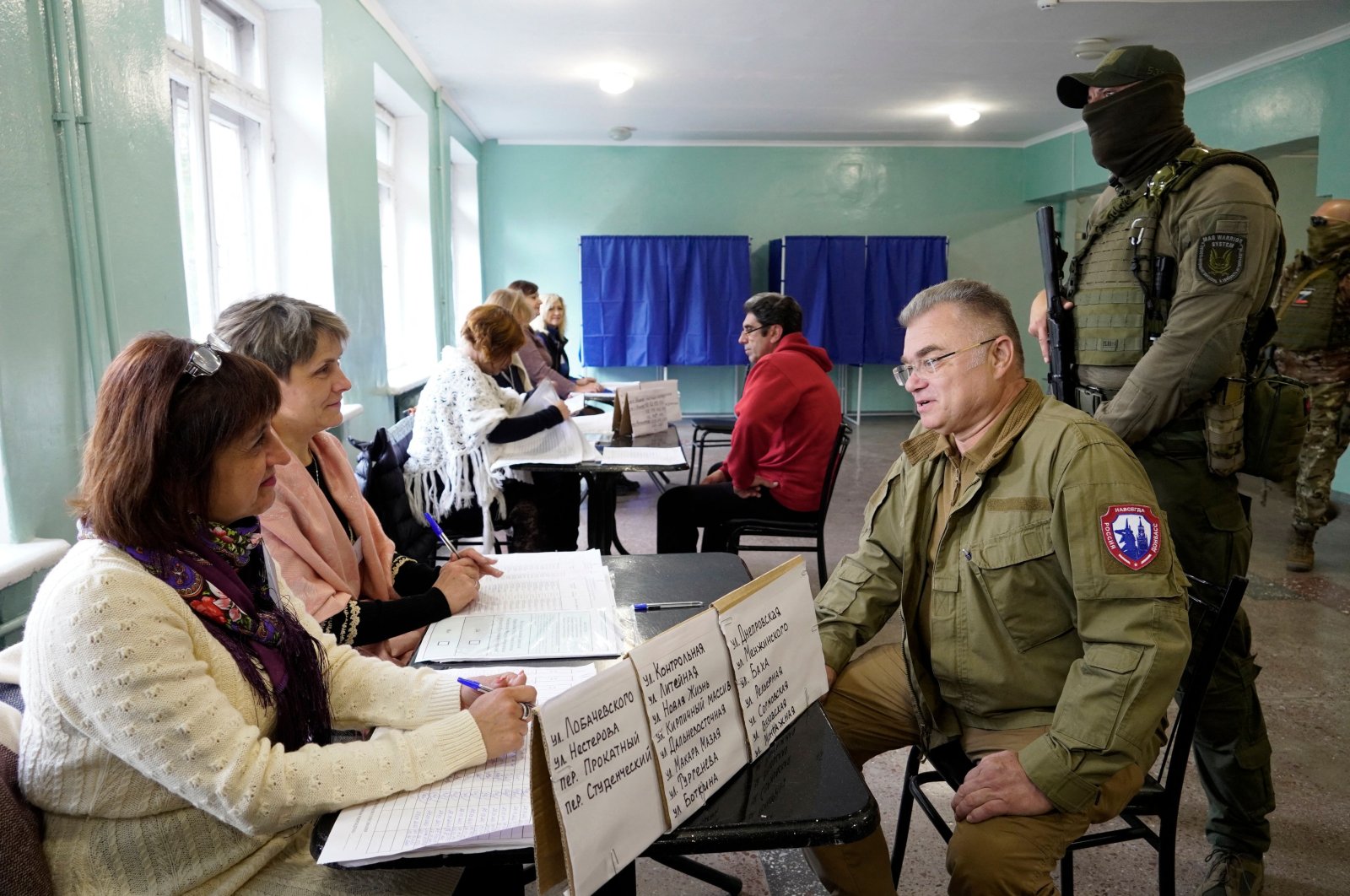 Konstantin Ivashchenko (3rd R), former CEO of the Azovmash plant and appointed pro-Russian mayor of Mariupol, visits a polling station, Mariupol, Ukraine, Sept. 27, 2022. (AFP Photo)