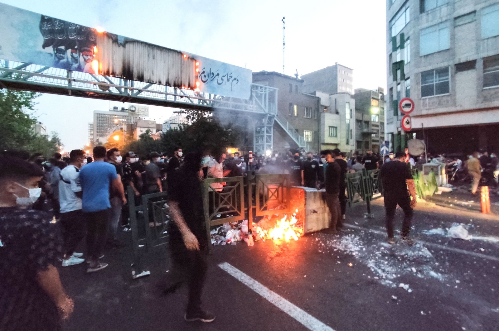 Iranian demonstrators burn a rubbish bin during a protest for Mahsa Amini, Tehran, Iran, Sept. 21, 2022. (AFP Photo)