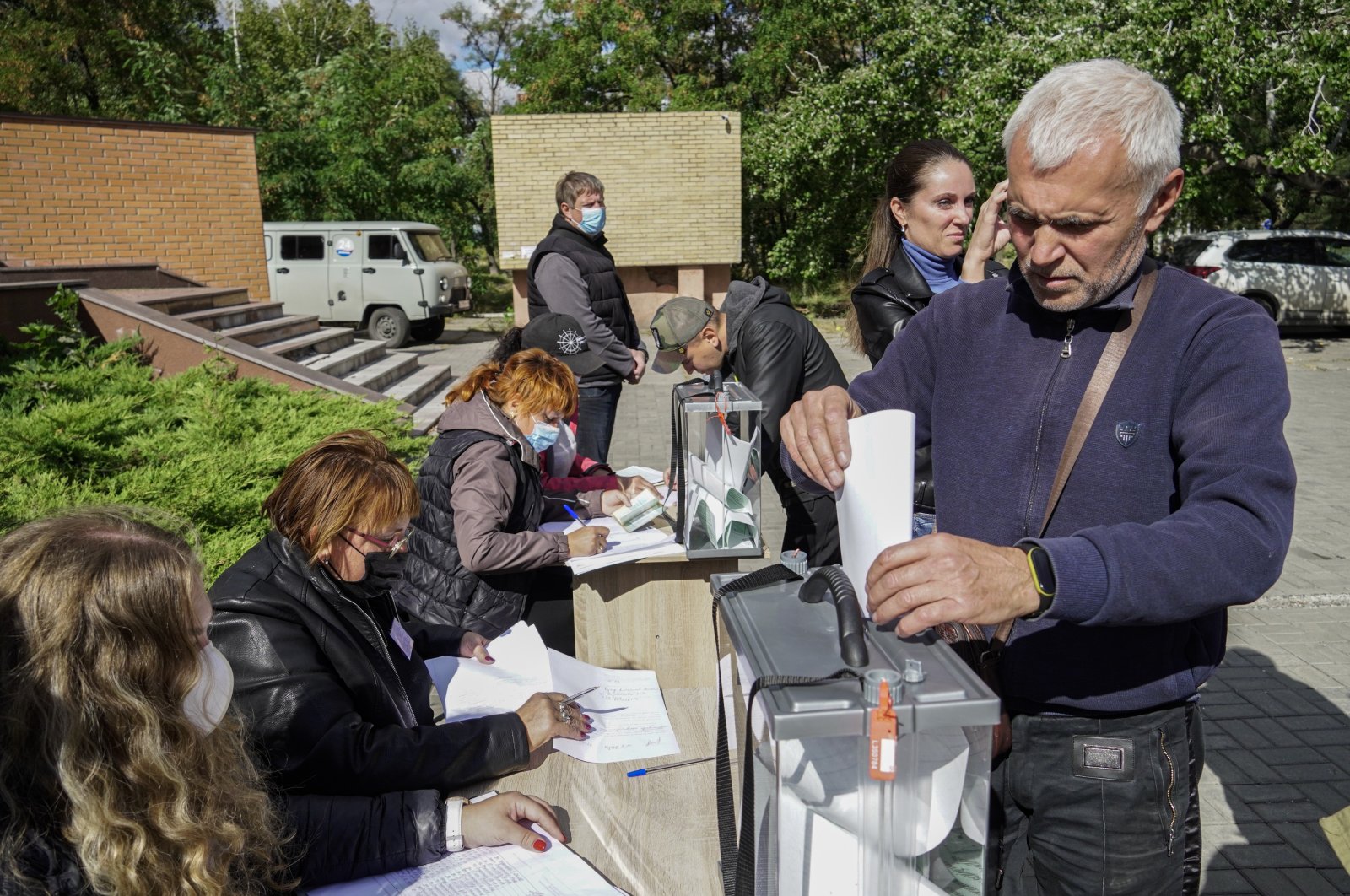 A man casts his ballot during a referendum on the joining of Russian-controlled regions of Ukraine to Russia, at an outdoor polling station in Mariupol, eastern Ukraine, Sept. 25, 2022. (EPA Photo)