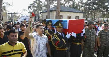Azerbaijani officers carry the coffin of their comrade Sabuhi Ahmadov during a mass funeral for troops killed during clashes on the border with Armenia, at the cemetery near Baku, Azerbaijan, Sept. 14, 2022. (EPA)