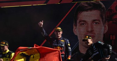 Max Verstappen (C) celebrates with Charles Leclerc (L) and George Russell (R) on the podium after the Italian Formula One Grand Prix at the Autodromo Nazionale circuit, Monza, Italy, Sept.11, 2022. (AFP Photo)