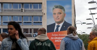 People pass by an election poster in Sarajevo, Bosnia-Herzegovina, Sept. 25, 2022. (REUTERS Photo)