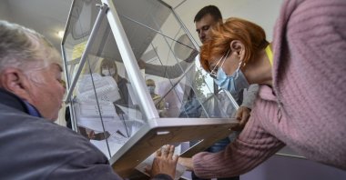 Local election officials pull out ballots for vote counting in a so-called referendum, Melitopol, Ukraine, Sept. 27, 2022. (EPA Photo)