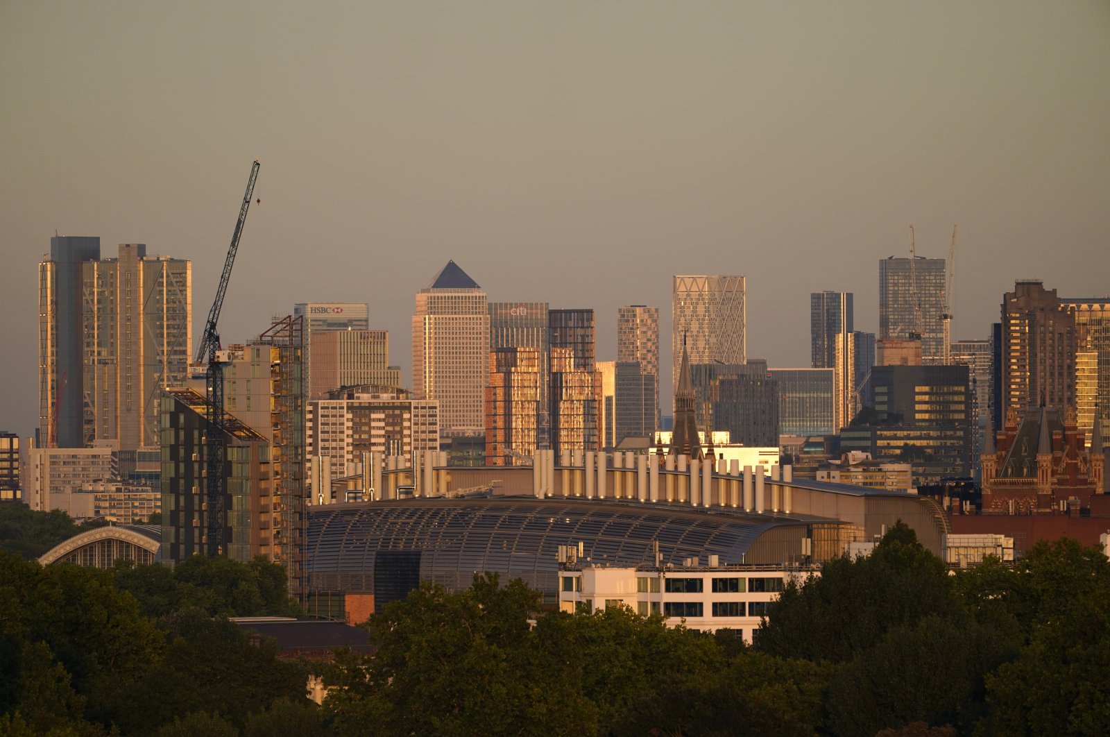 The skyscrapers of the financial district of Canary Wharf, at sunset in London, Britain, Aug. 11, 2022. (AP Photo)