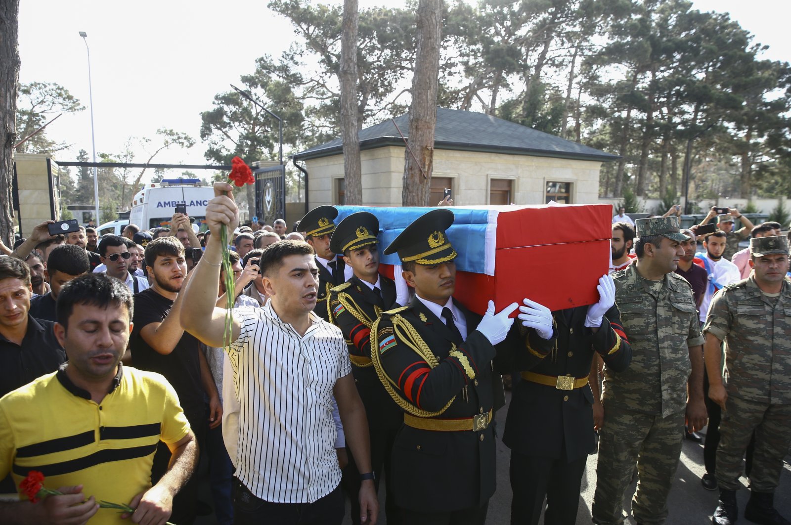 Azerbaijani officers carry the coffin of their comrade Sabuhi Ahmadov during a mass funeral for troops killed during clashes on the border with Armenia, at the cemetery near Baku, Azerbaijan, Sept. 14, 2022. (EPA)