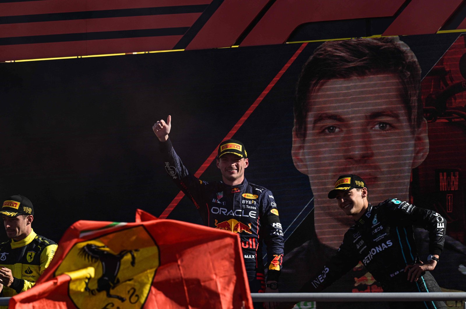 Max Verstappen (C) celebrates with Charles Leclerc (L) and George Russell (R) on the podium after the Italian Formula One Grand Prix at the Autodromo Nazionale circuit, Monza, Italy, Sept.11, 2022. (AFP Photo)