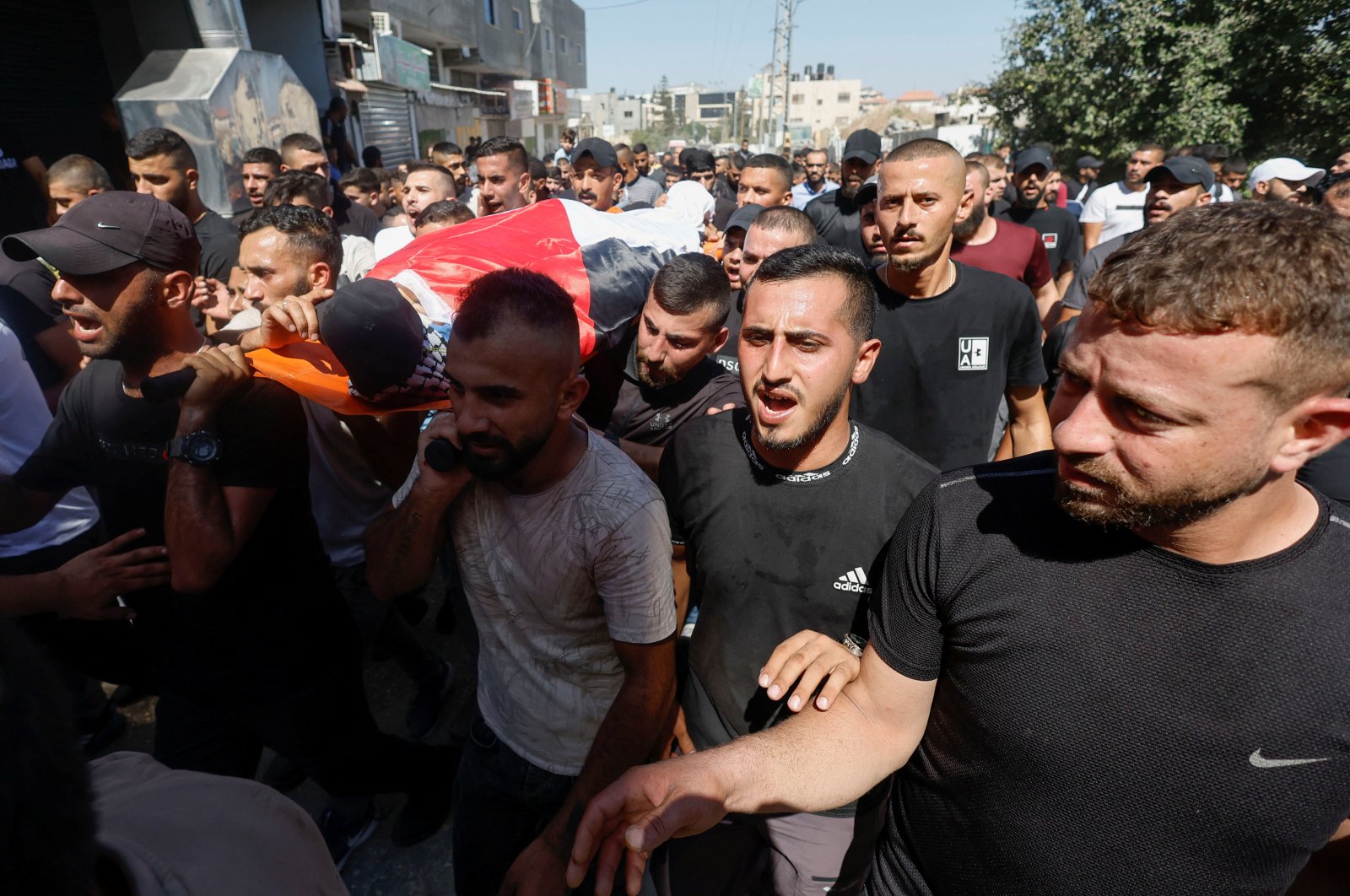 Mourners carry the body of Abdulrahman Khazem, who was killed by Israeli forces in a raid, during his funeral in Jenin, Israeli-occupied West Bank, Sept. 28, 2022. (Reuters Photo)