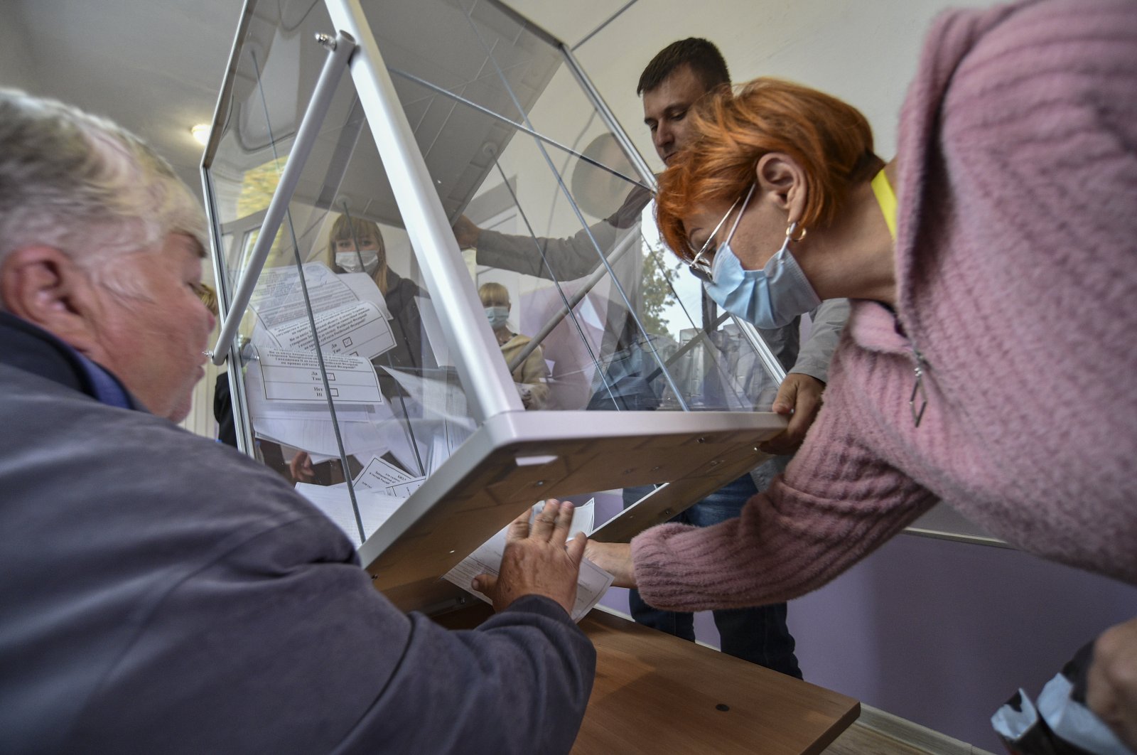 Local election officials pull out ballots for vote counting in a so-called referendum, Melitopol, Ukraine, Sept. 27, 2022. (EPA Photo)