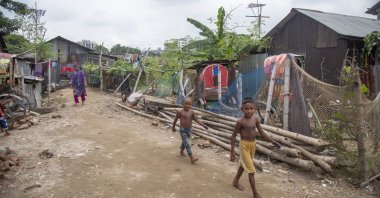 Children walk in the Kalyanpur slum area in Dhaka, Bangladesh, Sept. 11. (EPA Photo)