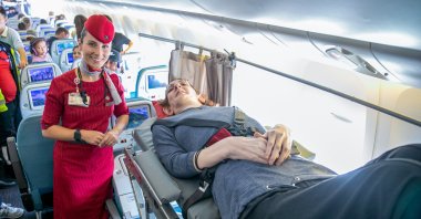 Rumeysa Gelgi lies on the stretcher aboard the plane, in Istanbul, Türkiye, Sept. 28, 2022. (AA PHOTO) 