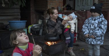 Margaryta Tkachenko feeds her 9-month-old daughter Sophia in the recently liberated town of Izium, Ukraine, Sept. 25, 2022. (AP Photo)