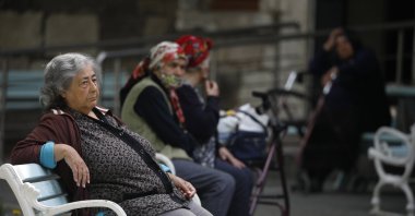 Elderly residents of the Darülaceze nursing home sit on benches, in Istanbul, Türkiye, May 10, 2021. (DHA PHOTO)
