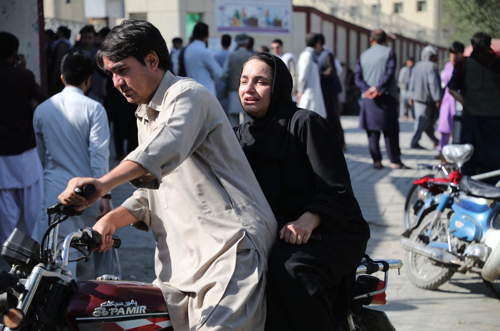 A woman arrives on a motorbike to search for a relative at a hospital after a blast in a learning center in the Dasht-e-Barchi area of Afghanistan&#039;s capital. Kabul, Sept. 30, 2022 (AFP Photo)