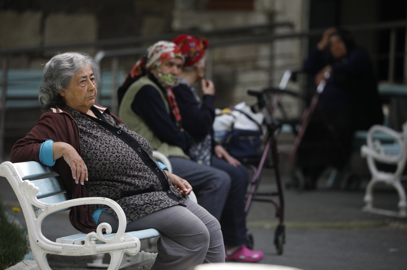 Elderly residents of the Darülaceze nursing home sit on benches, in Istanbul, Türkiye, May 10, 2021. (DHA PHOTO)