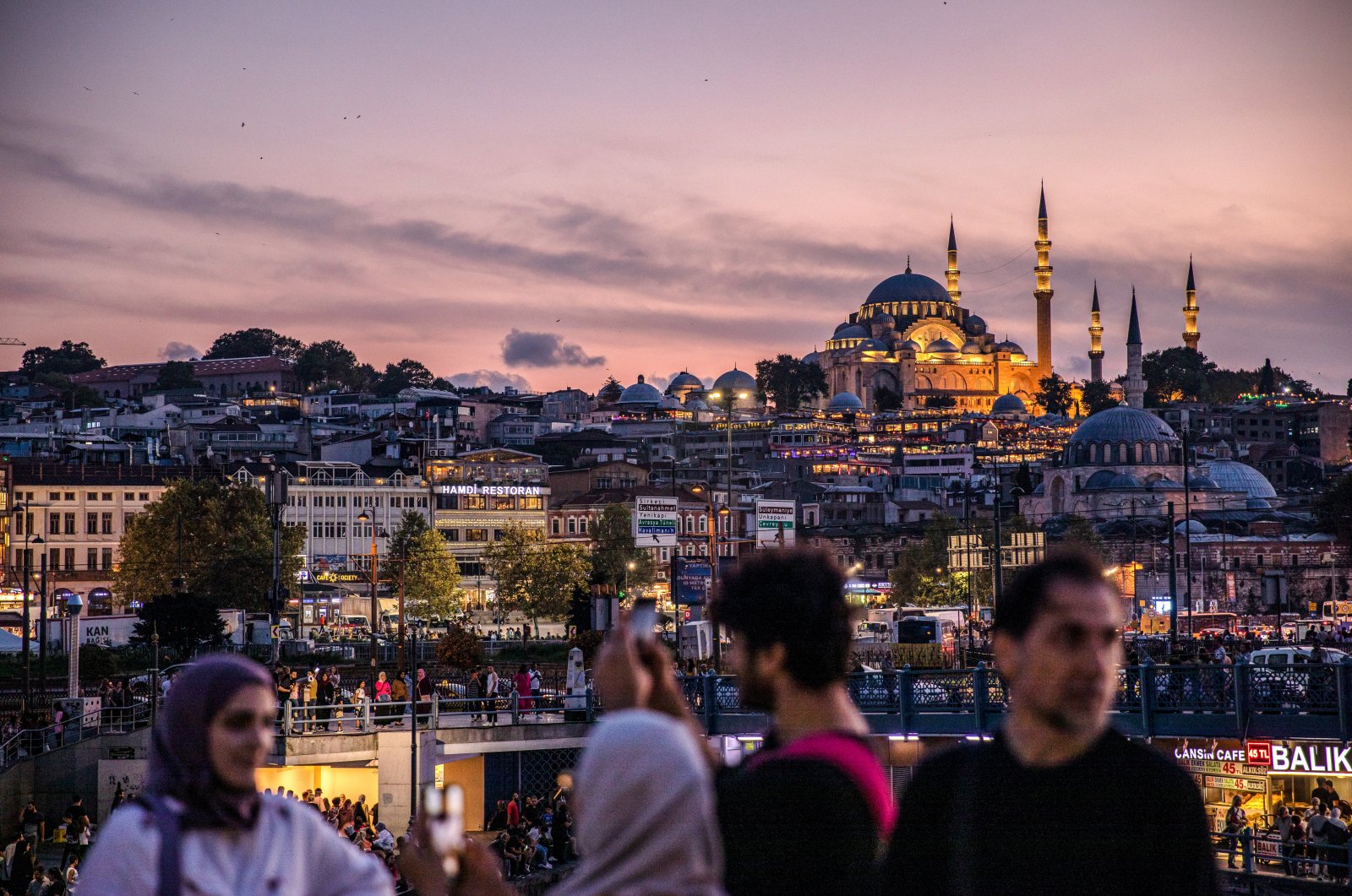 People are seen standing on the terrace of the city lines ferry at sunset in Istanbul and Süleymaniye Mosque in the background, creating a beautiful view of the clouds, Türkiye, Sept. 3, 2022. (Reuters File Photo)
