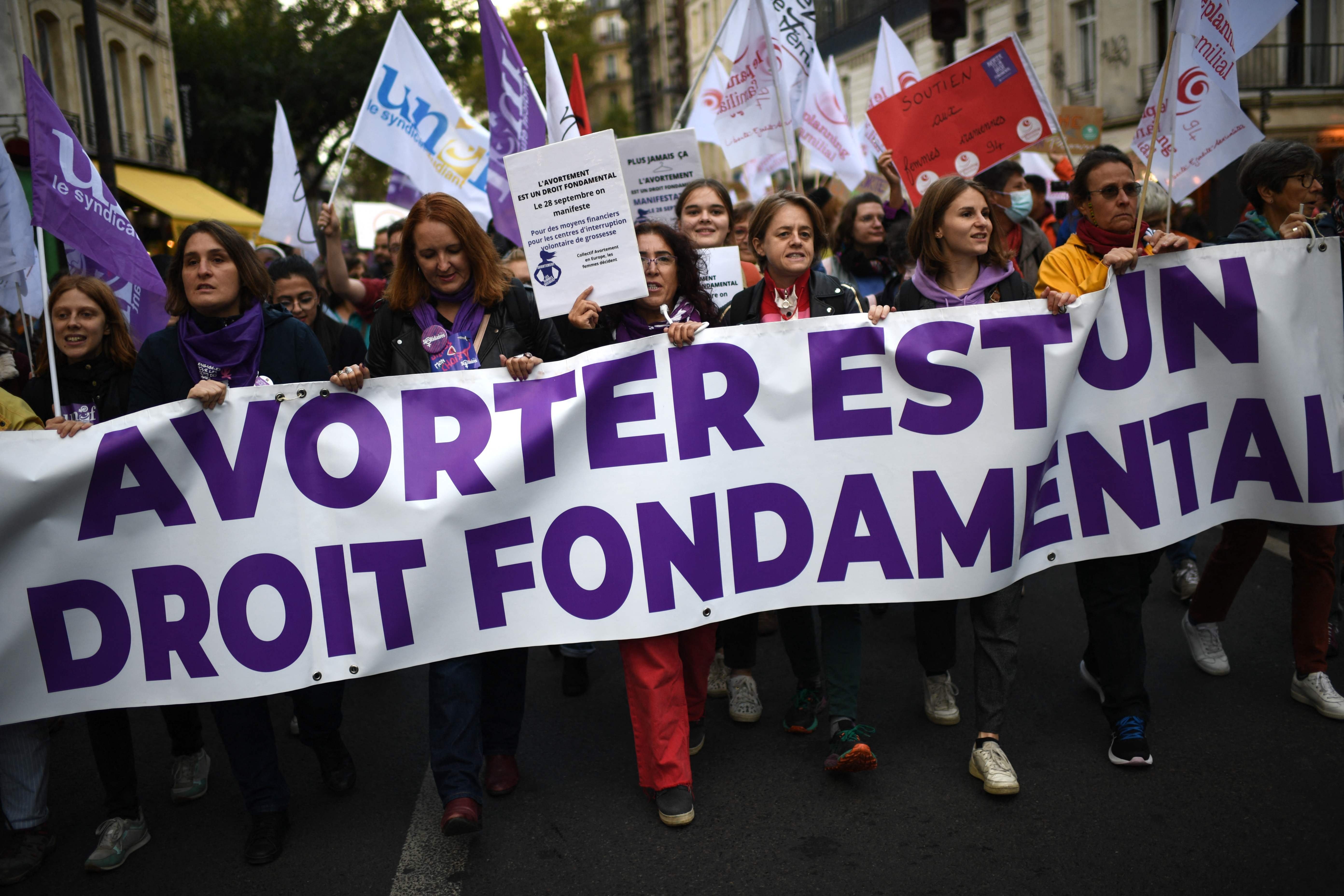 Demonstrators march behind a banner reading &quot;Abortion is a fundamental right&quot; as they participate in an abortion rights rally on the annual International Safe Abortion Day in Paris, Sept. 28, 2022. (Photo by AFP)