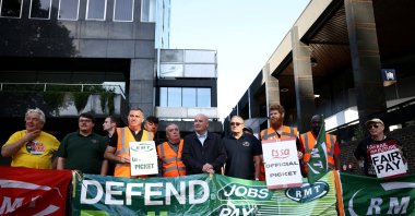 Mick Lynch, general secretary of the National Union of Rail, Maritime and Transport Workers, joins other union members on strike at a picket line outside Euston railway station in London, Britain, Aug. 20, 2022. (Reuters Photo)