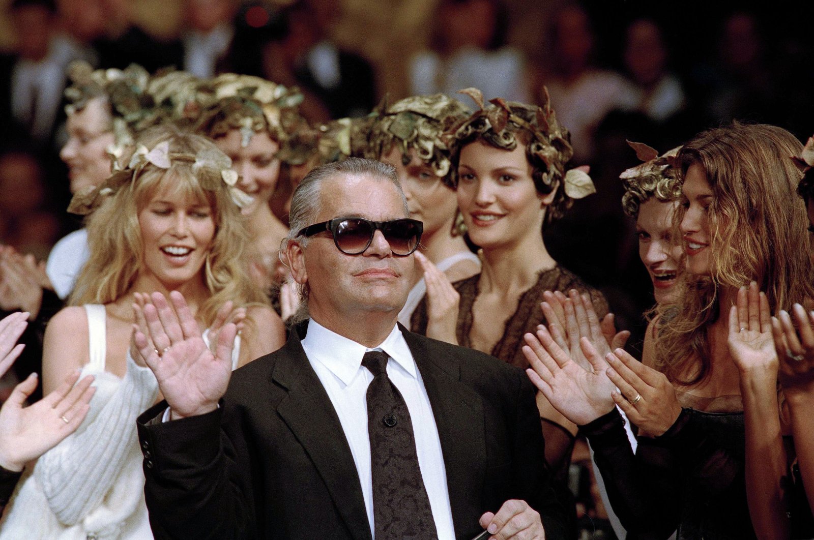 German fashion designer Karl Lagerfeld acknowledges the applause of his models at the end of the show he designed for the French fashion house Chanel, for the 1993-94 Fall-Winter haute couture collection, Paris, France, July 20, 1993. (AP Photo)