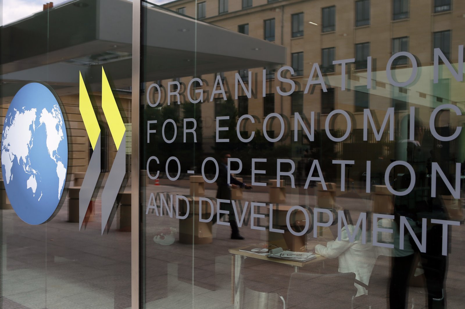 The logo at the entrance of the Organisation for Economic Co-operation and Development (OECD) headquarters in Paris, France, June 7, 2017. (AP Photo)