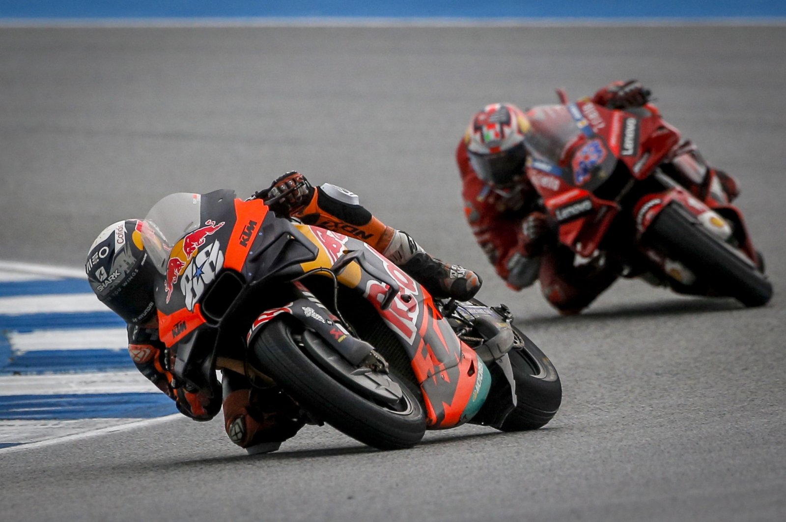 Portuguese MotoGP rider Miguel Oliveira (L) of Red Bull KTM Factory Racing in action ahead of Australian MotoGP rider Jack Miller of Ducati Lenovo Team during the Motorcycling Grand Prix of Thailand at Chang International Circuit, Buriram province, Thailand, Oct. 2, 2022.  (EPA Photo)