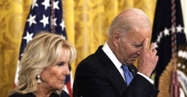 U.S. President Joe Biden crosses himself as he stands next to first lady Jill Biden during the Hispanic Heritage Month celebration in the East Room at the White House, Washington, U.S., Sept. 30, 2022.  (EPA Photo)