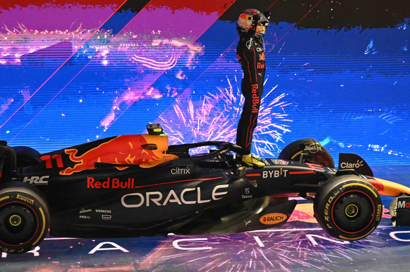 Winner Red Bull Racing&#039;s Mexican driver Sergio Perez celebrates after the Formula One Singapore Grand Prix night race at the Marina Bay Street Circuit, Singapore, Oct. 2, 2022. (AFP Photo)