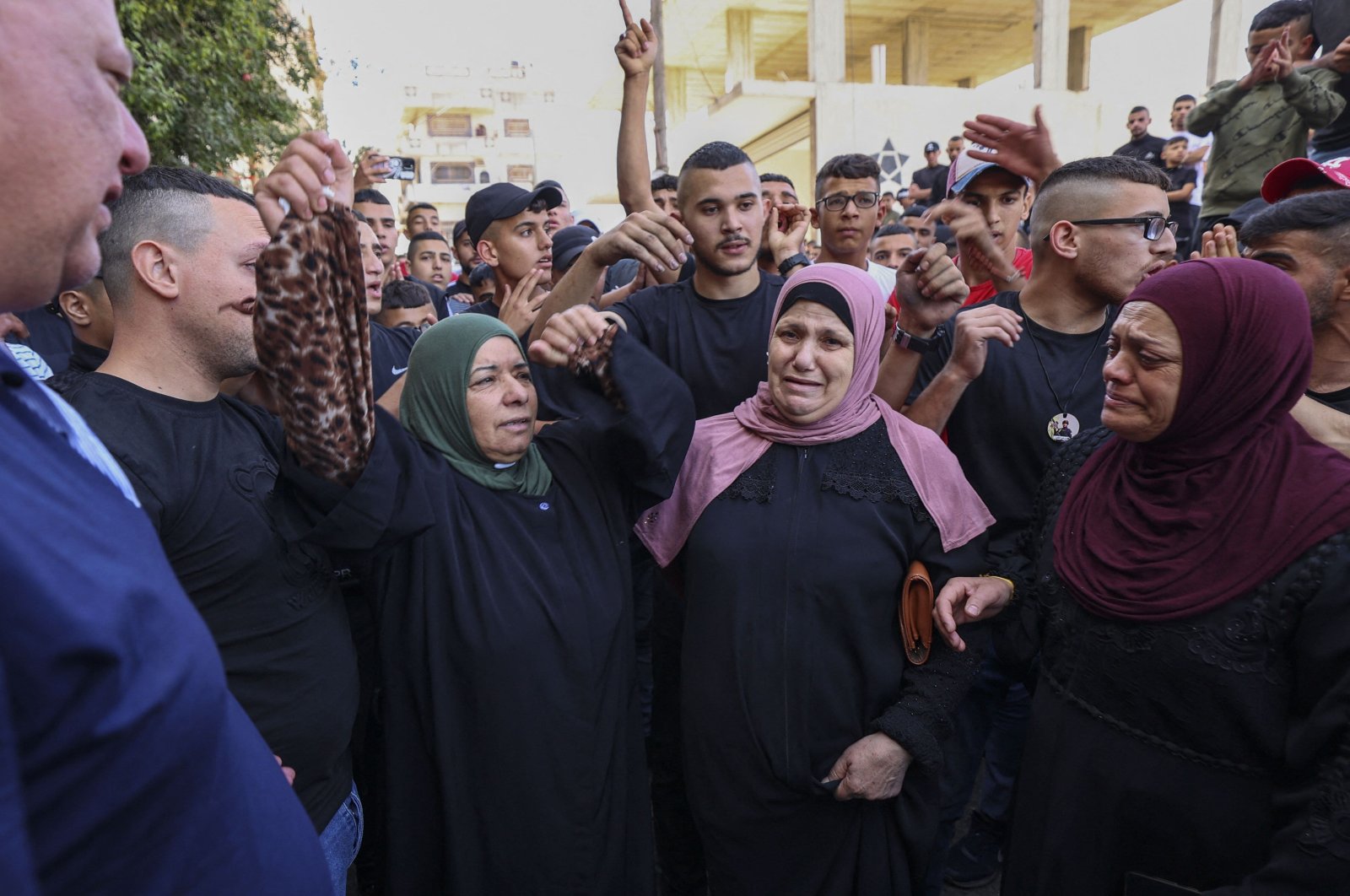 Relatives of Palestinian Bassel Basbous, killed at dawn by Israeli forces, mourn as they gather at the Al-Jalazun refugee camp, near the Israeli settlement of Beit El. West Bank, on Oct.3, 2022. ( AFP)