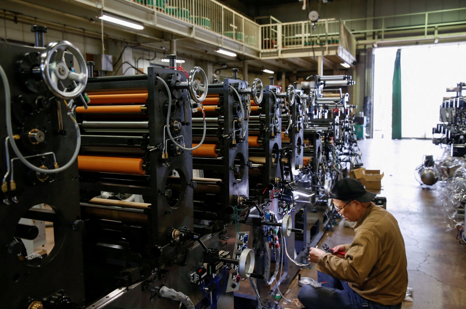 A worker checks machinery at a factory in Higashiosaka, Japan, June 23, 2022. (Reuters Photo)