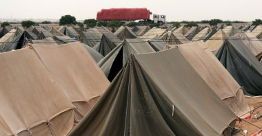 People affected by floods wait for relief at a tent camp on the outskirts of Karachi, Sindh province, Pakistan, Sept. 26, 2022. (EPA Photo)