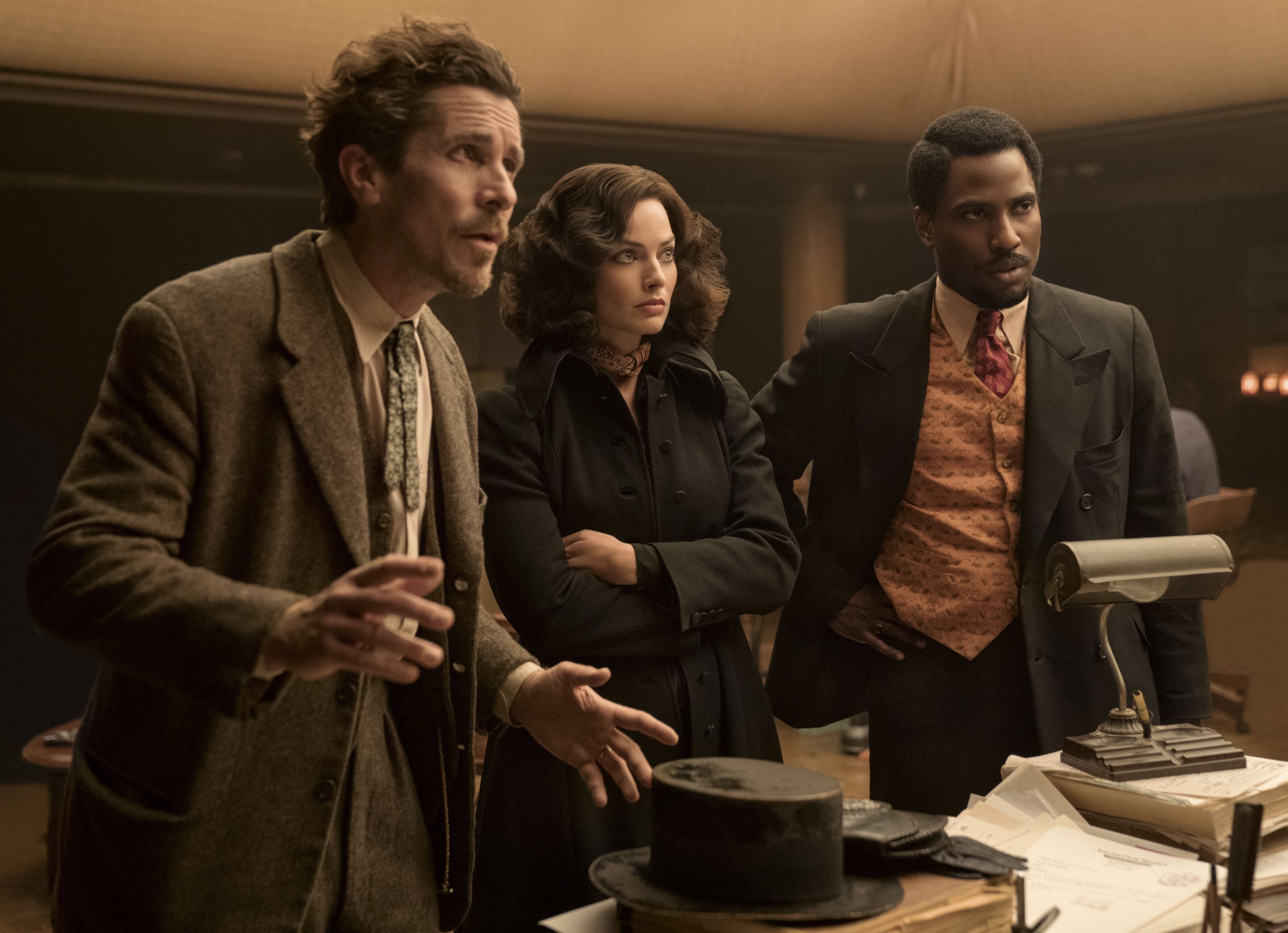 This image released by 20th Century Studios shows, from left, Christian Bale, Margot Robbie and John David Washington in a scene from 
