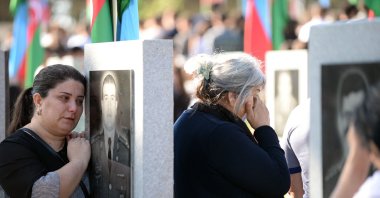 Relatives and friends of servicemen killed in six weeks of fighting for the Karabakh region visit a military cemetery in Baku on September 27, 2022, on the second anniversary of the conflict. (AFP Photo)