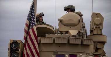 American soldiers sit in a fighting vehicle near a prison that was attacked by Daesh militants in Hassakeh, Syria, Feb. 8, 2022. (AP Photo)