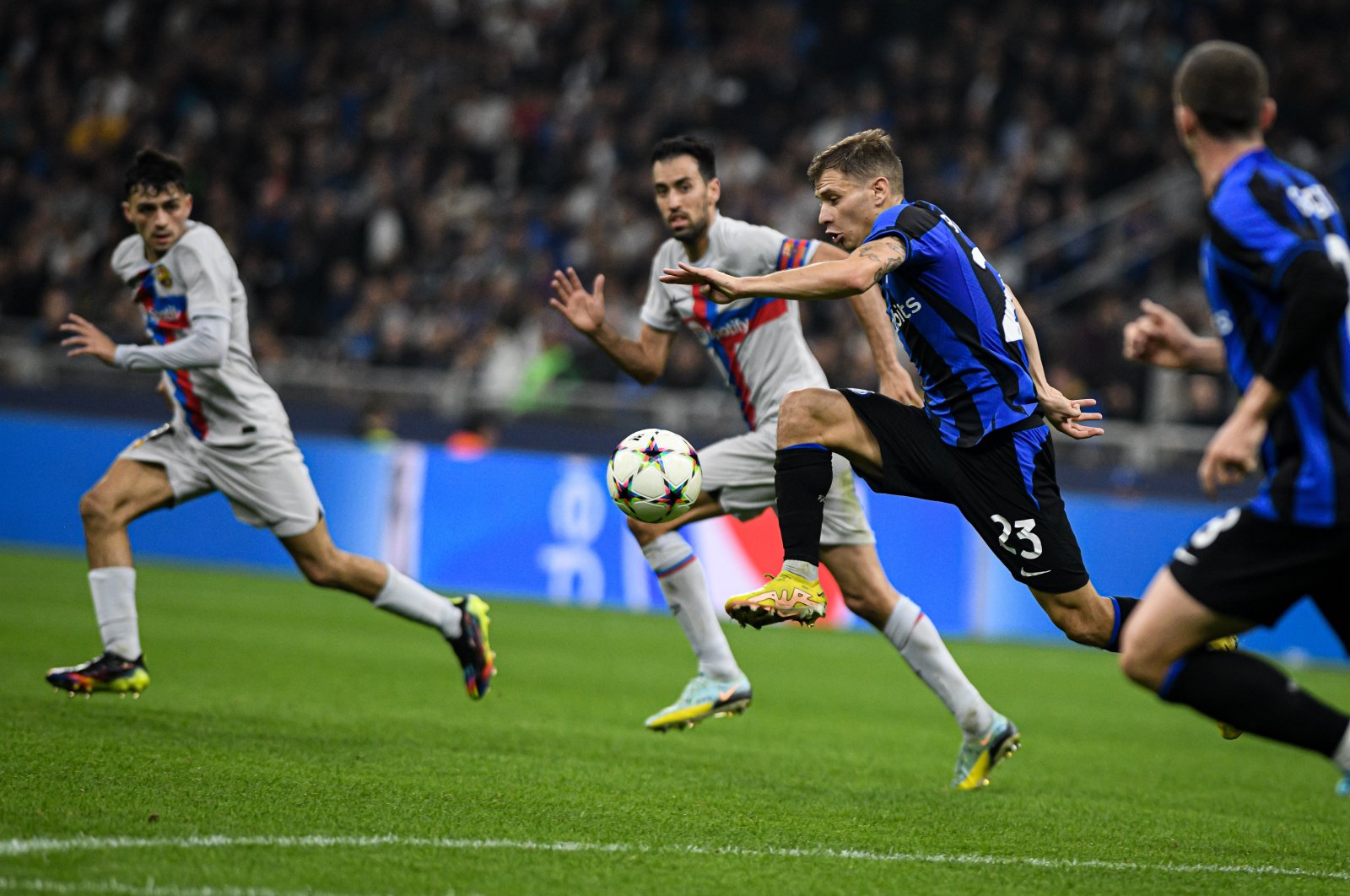 Nicolo Barella takes on Sergio Busquets in the UEFA Champions League Group C match between Inter Milan and Barcelona at the San Siro Stadium. Milan, Italy Oct. 4, 2022. (AA Photo)