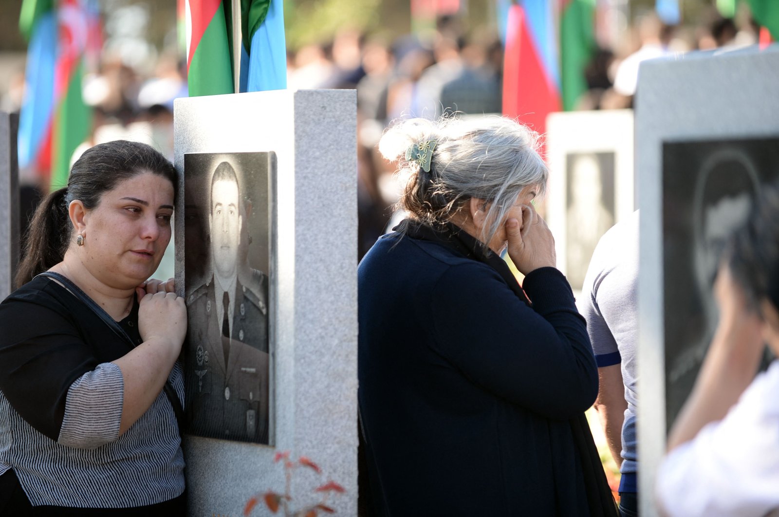 Relatives and friends of servicemen killed in six weeks of fighting for the Karabakh region visit a military cemetery in Baku on September 27, 2022, on the second anniversary of the conflict. (AFP Photo)