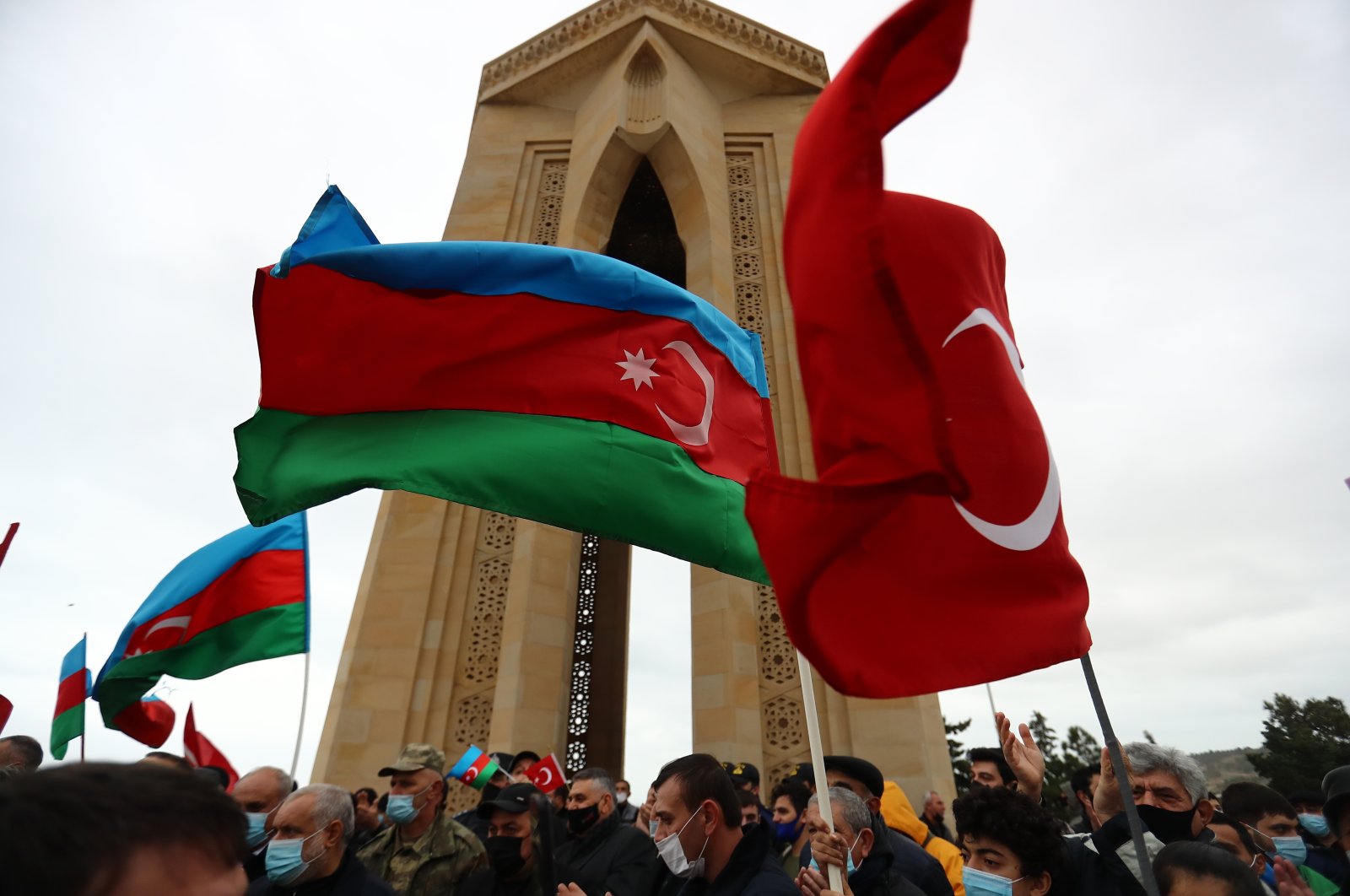 Azerbaijanis wave national flags as they celebrate entry of troops in Nagorno-Karabakh&#039;s Aghdam region in Baku, Azerbaijan, Nov. 20, 2020. (AP Photo)