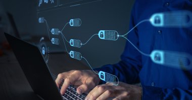 A person is working on a computer in this concept photo. (Shutterstock Photo)
